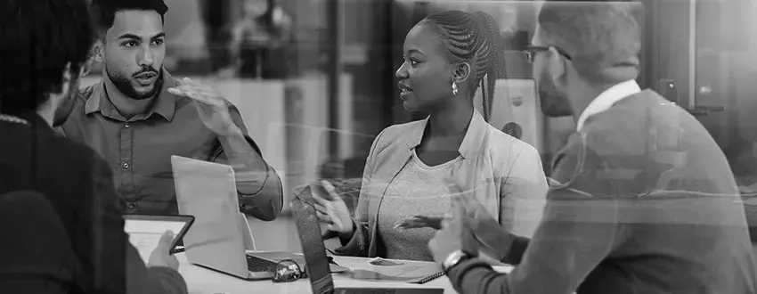 People around table using MFT in their organization